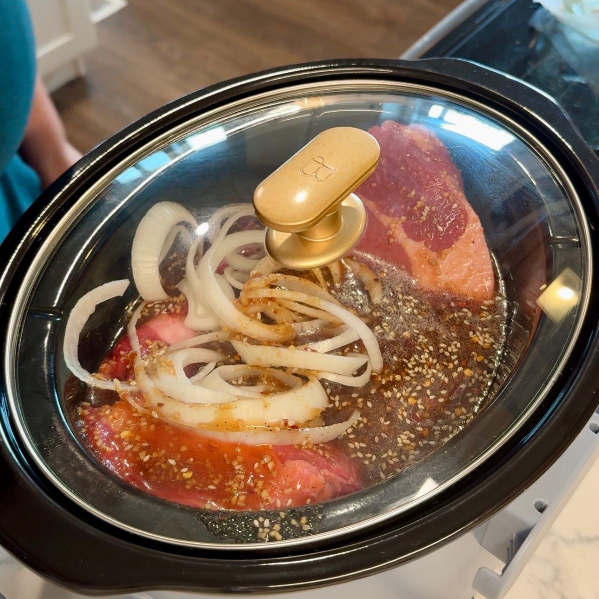 chuck roast, sliced onions, sauce mixture in slow cooker