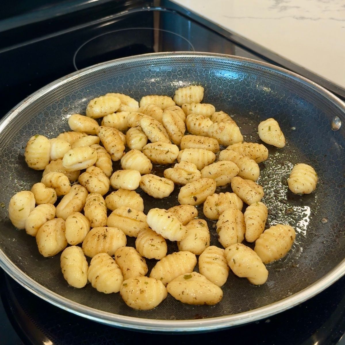 cooked gnocchi in large skillet