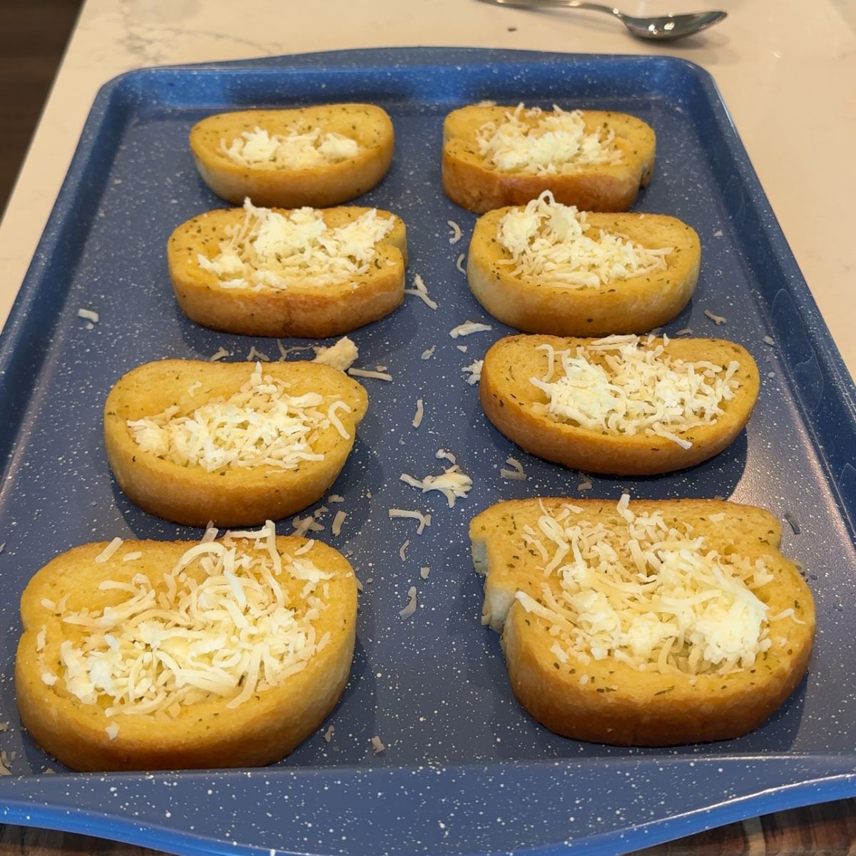 mozzarella cheese on 8 texas toast on sheet pan