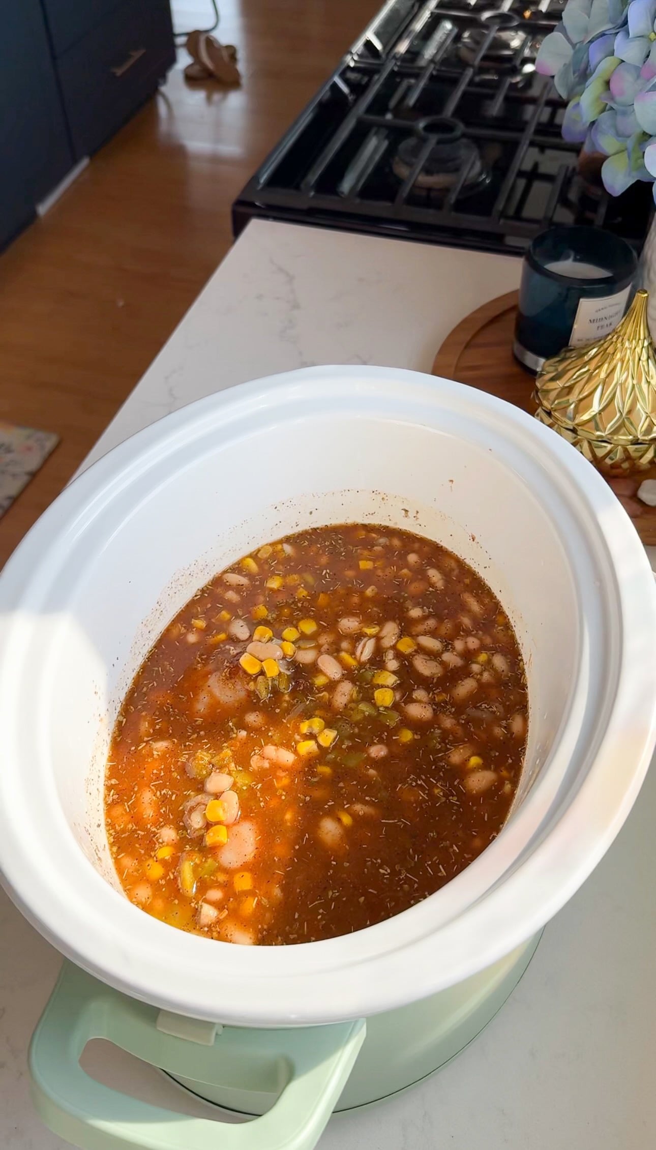 Crockpot White Chicken Chili INGREDIENTS 1.5-2 lb chicken breast 16 oz chicken bone broth 10 oz green enchilada sauce 8 oz mild diced green chilies 15 oz canned corn 2 (15 oz) great northern beans 1 tablespoon minced garlic 2 teaspoon chili powder 1 teaspoon onion powder 1 teaspoon garlic powder 1 teaspoon cumin 1 teaspoon oregano 1 teaspoon black pepper 1 teaspoon smoked paprika Salt to taste 8 oz softened cream cheese 1 tablespoon cornstarch 1 tablespoon cold water ½ cup freshly chopped cilantro ¼ cup sour cream ½ cup freshly shredded Monterey Jack cheese Garnish with jalapeño, tortilla strips, and cilantro INSTRUCTIONS 1. Add chicken breast to bottom of crockpot. 2. Next add 2 cups chicken bone broth, green enchilada sauce, juice of 2 limes, diced green chilies, rinsed canned corn and great northern beans, minced garlic, and seasonings listed above. 3. Make sure the chicken is submerged in the bone broth prior to cooking. Cover with lid, and cook on low for 3-4 hours or high for 2-3 hours or until the chicken easily shreds. I recommend cooking on low for this recipe, to help enhance the flavors. 4. Once the chicken is cooked, keep slow cooker set to low, remove chicken from crockpot. Shred and set aside. 5. Soften cream cheese in the microwave in 30 second increments for about a minute total. 6. Add softened cream cheese to slow cooker and whisk briskly until all the cream cheese has melted and is well combined. 7. Next add cornstarch slurry (1 tablespoon cornstarch and 1 tablespoon cold water mixed together) into the slow cooker. This will help thicken the chili. If you prefer a thinner chili consistency, you can omit it. 8. Add shredded chicken back into the crockpot. 9. Next, add ½ cup freshly chopped cilantro, sour cream, and Monterey Jack cheese. 10. Let it cook on low heat for an additional 30 minutes. 11. Then serve with your preferred toppings such as jalapeños, cilantro, tortilla strips or additional sour cream.