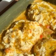 Cheddar bay biscuit chicken pot pie with golden garlic butter biscuits in a green baking dish.
